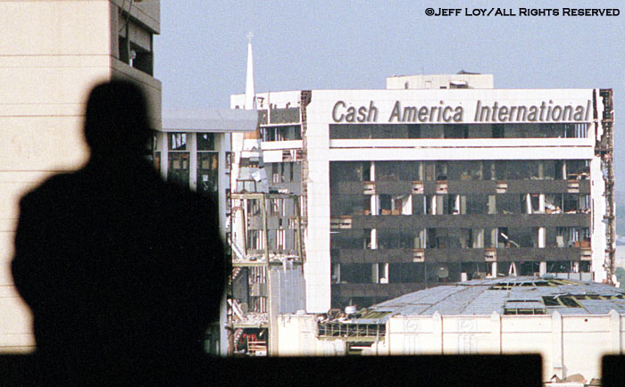 A RadioShack Corporation security guard looks toward buildings that suffered a direct hit from a tornado. The storm killed two people and caused millions of dollars in damage to the downtown Fort Worth area.